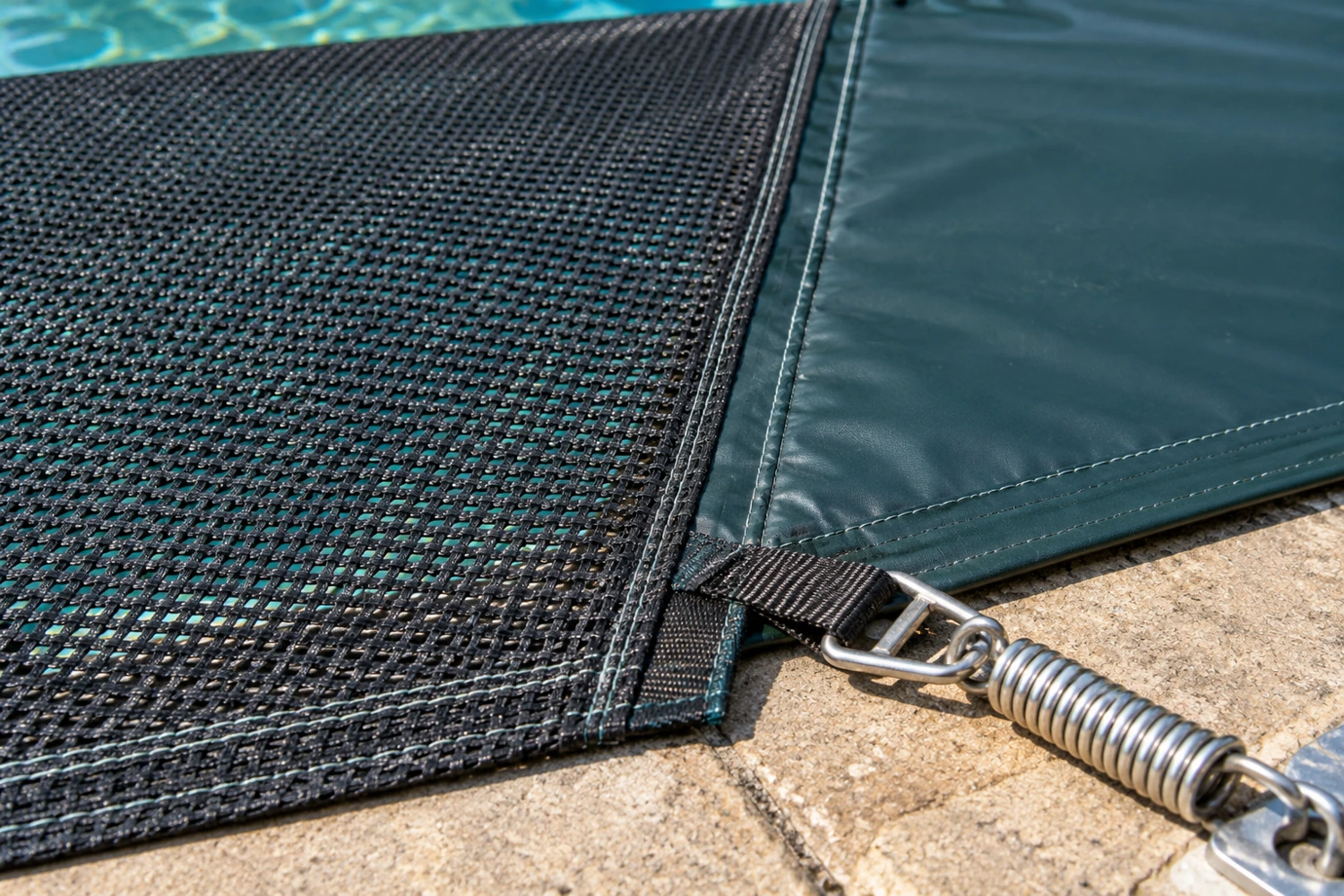 Illustrative photo of open mesh beside a solid cover sheet, with stitching, a strap, buckle and metal spring on the deck; not a material or load test.